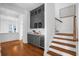 Hallway with gray built-in cabinetry, wine cooler and hardwood floors at 2312 Bucktail Ct, Mount Pleasant, SC 29466