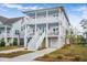Two-story light purple house with white trim, double garage, and front porch at 2312 Bucktail Ct, Mount Pleasant, SC 29466