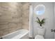Bathroom with beige tile, a shower/tub combo, and a round window at 2312 Bucktail Ct, Mount Pleasant, SC 29466