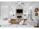 Bright and airy living room with white sofas and a fireplace at 2312 Bucktail Ct, Mount Pleasant, SC 29466