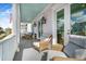 Relaxing front porch with wicker seating and American Flag at 2312 Bucktail Ct, Mount Pleasant, SC 29466