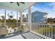 Relaxing screened porch with white railings and outdoor seating overlooking backyard at 2312 Bucktail Ct, Mount Pleasant, SC 29466