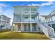Two-story house with light blue accents, a spacious deck and stairs at 2312 Bucktail Ct, Mount Pleasant, SC 29466