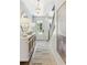 Light and airy entryway with white console table and statement art at 483 Queenview Ln, Charleston, SC 29414