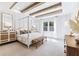 Main bedroom with a four-poster bed, exposed beams, and a large window at 483 Queenview Ln, Charleston, SC 29414