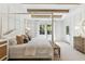 Main bedroom with a four-poster bed, exposed beams, and a large window at 483 Queenview Ln, Charleston, SC 29414