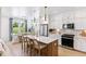 Open concept kitchen with island, white cabinets, and stainless steel appliances at 483 Queenview Ln, Charleston, SC 29414
