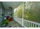 Relaxing screened porch with wooded views, ceiling fan, and outdoor furniture at 115 Claret Cup Way, Charleston, SC 29414