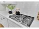 Close-up of a modern gas cooktop with white subway tile backsplash at 1054 Old Cypress, Hanahan, SC 29410