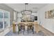 Modern dining room with a light wood table, chandelier, and access to a patio at 1054 Old Cypress, Hanahan, SC 29410