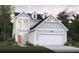 Two-story house with gray siding, two-car garage, and balcony at 266 Wappoo Trace Ln, Summerville, SC 29486