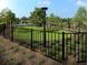 Fenced dog park with grassy area and modern lighting at 974 Dusk Dr, Summerville, SC 29486