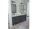 Modern double vanity bathroom with gray cabinets and marble tile at 369 Wappoo Trace Ln, Summerville, SC 29486
