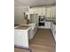 Modern kitchen with white cabinets, island, and stainless steel appliances at 369 Wappoo Trace Ln, Summerville, SC 29486