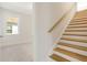 Wooden staircase with white risers and a light-colored handrail at 707 Maynard Ln, Summerville, SC 29486