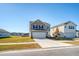 Two-story home with taupe siding, white garage door, and landscaping at 487 Pender Woods Dr, Summerville, SC 29486