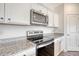 Modern kitchen with white cabinets and stainless steel appliances at 487 Pender Woods Dr, Summerville, SC 29486
