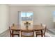 Bright dining room with sliding glass doors leading to backyard and wooden table at 487 Pender Woods Dr, Summerville, SC 29486