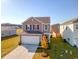 Two-story home with taupe siding, white garage door, and landscaping at 487 Pender Woods Dr, Summerville, SC 29486