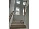 Bright, open staircase with natural wood railings and white risers at 357 Wappoo Trace Ln, Summerville, SC 29486