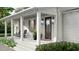 Inviting front porch with rocking chairs and decorative planters at 5209 Seewee Rd, Awendaw, SC 29429
