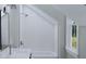 Charming bathroom with white tile, a bathtub, and a window at 5209 Seewee Rd, Awendaw, SC 29429