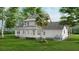 Rear view of two story farmhouse with large backyard at 5209 Seewee Rd, Awendaw, SC 29429