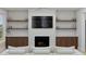 Cozy living room with fireplace, built-in shelving, and comfortable seating at 5209 Seewee Rd, Awendaw, SC 29429