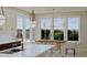 Bright eat-in kitchen with large windows and a wooden dining table at 5209 Seewee Rd, Awendaw, SC 29429