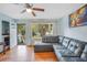 Living room with bay window, comfy sectional sofa and hardwood floors at 2503 S Hwy 17A, Summerville, SC 29483