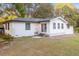 White house with black accents, a large backyard, and mature trees at 2503 S Hwy 17A, Summerville, SC 29483