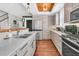 Bright kitchen boasts stainless steel appliances and wood flooring at 318 Simmons Ave, Summerville, SC 29483