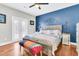 Main bedroom with hardwood floors and a blue accent wall at 318 Simmons Ave, Summerville, SC 29483