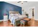 Main bedroom with a blue accent wall, king bed, and hardwood floors at 318 Simmons Ave, Summerville, SC 29483