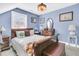 Charming bedroom with wooden sleigh bed and matching furniture in a light blue room at 318 Simmons Ave, Summerville, SC 29483