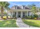 Charming house with a welcoming front porch and landscaped yard at 318 Simmons Ave, Summerville, SC 29483