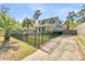 Gray house with a black fence, driveway, and lush green lawn at 318 Simmons Ave, Summerville, SC 29483