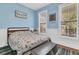 Blue bedroom with dinosaur bedding and large windows at 318 Simmons Ave, Summerville, SC 29483