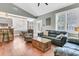 Open concept living room and kitchen with hardwood floors and a cozy sitting area at 318 Simmons Ave, Summerville, SC 29483