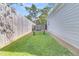 Small backyard with a wooden fence and a boat trailer at 318 Simmons Ave, Summerville, SC 29483
