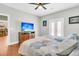 Bright bedroom with hardwood floors, king bed, and a flat-screen TV at 318 Simmons Ave, Summerville, SC 29483
