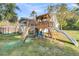 Backyard with a wooden playset and climbing wall at 318 Simmons Ave, Summerville, SC 29483