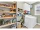 Laundry room with washer, dryer, and ample shelving at 318 Simmons Ave, Summerville, SC 29483
