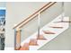 Modern staircase with wood treads, metal cable railing, and safety gate at 318 Simmons Ave, Summerville, SC 29483