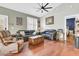 Relaxing living room featuring hardwood floors, comfy leather sofas, and a ceiling fan at 318 Simmons Ave, Summerville, SC 29483