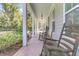 Inviting front porch with rocking chairs and lush landscaping at 318 Simmons Ave, Summerville, SC 29483