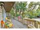 Relaxing deck with seating, overlooking a wooded area at 513 Dolphin St, Edisto Island, SC 29438