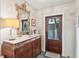 Hallway featuring an antique cabinet, mirror, and access to the kitchen and backyard at 40 1/2 State St, Charleston, SC 29401