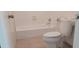 Clean bathroom with white tile, bathtub, and toilet at 8266 N Highway 17, McClellanville, SC 29458