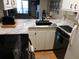 Modern kitchen with white cabinets, marble countertops, and black appliances at 265 Sea Cloud Cir, Edisto Island, SC 29438